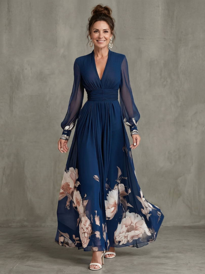 Abito lungo elegante con maniche velate e orlo floreale
